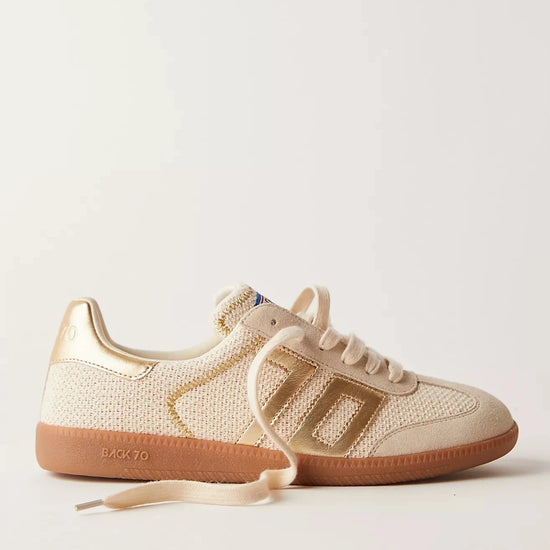 Beige sneakers with brown soles on a light gray background