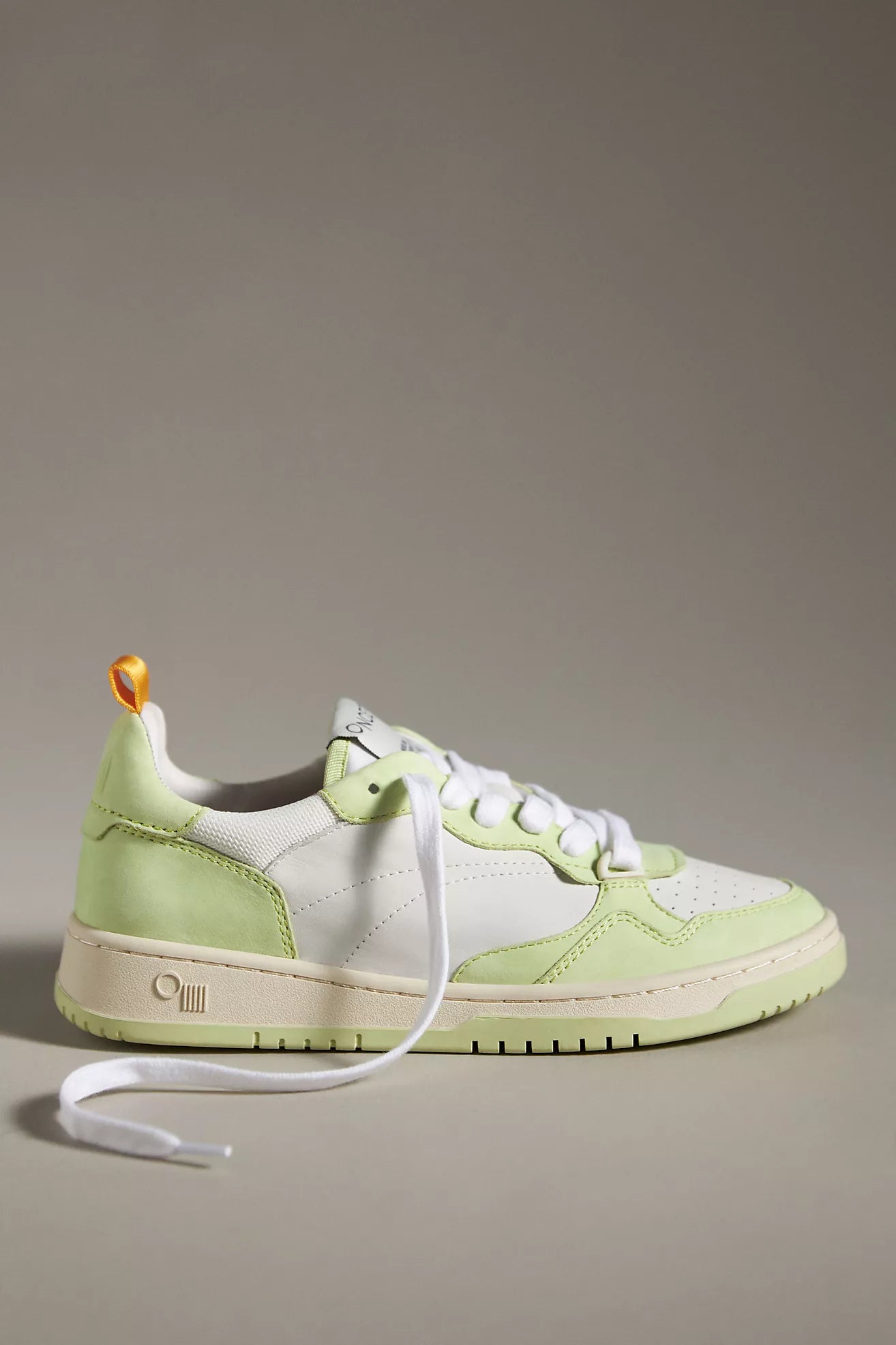 A side view of an Oncept Sneakers Phoenix NYC in Green Matcha colorway. The sneakers showcase a sleek design with white and light green leather panels, white laces, and a beige sole.