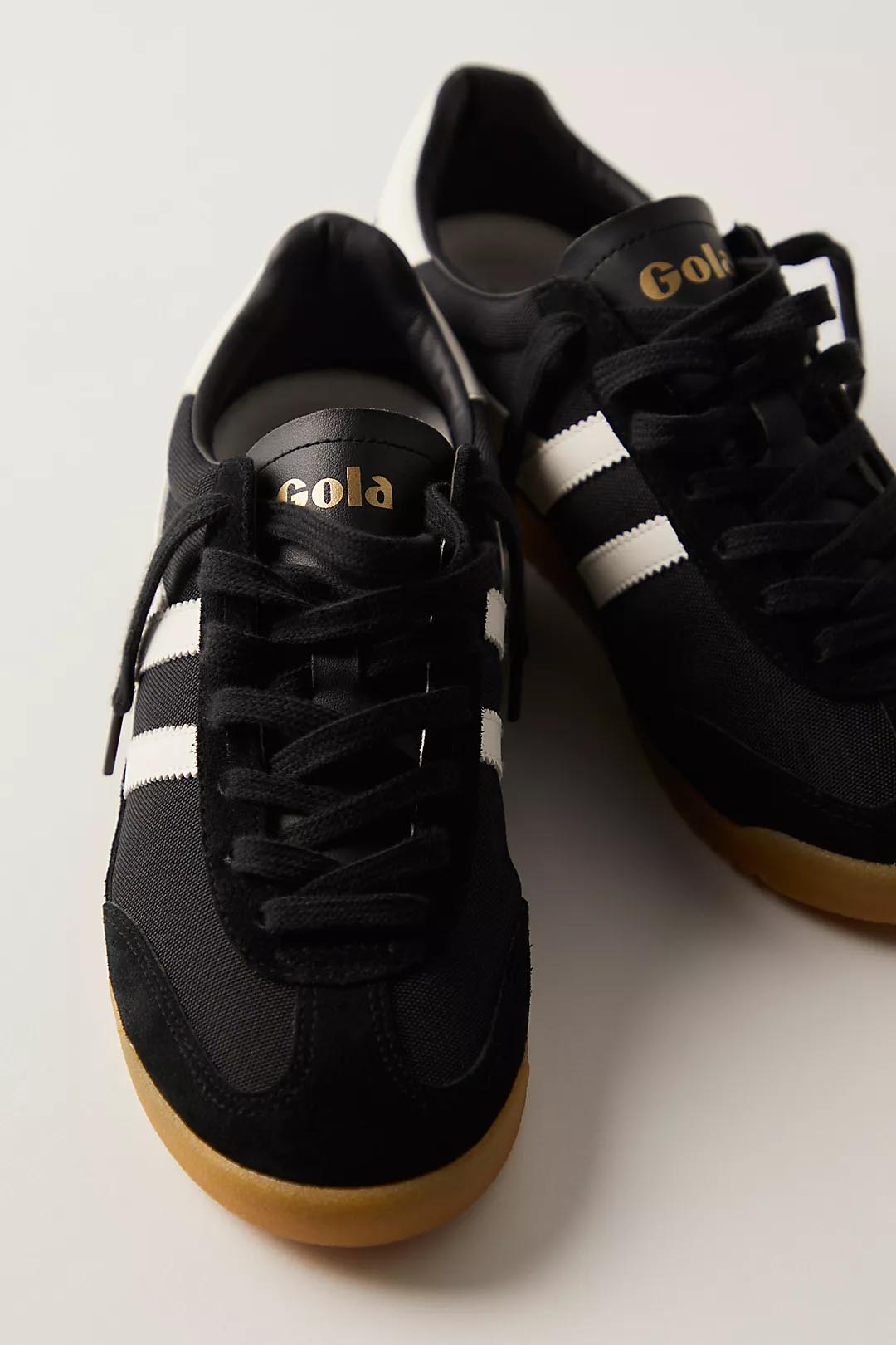 a black gola Torpedo sneaker with white strtipes and a retro gum sole with black laces