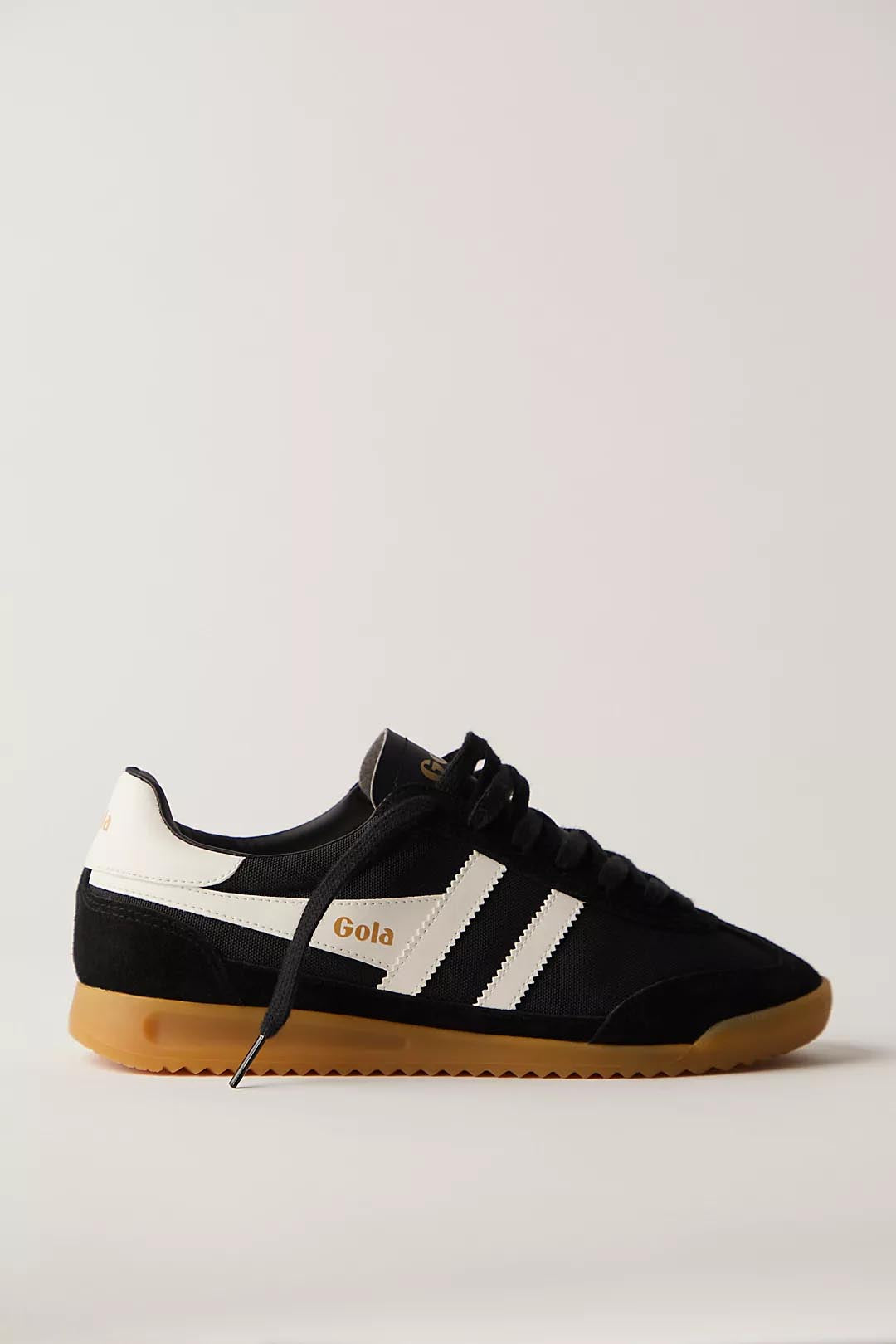 a black gola Torpedo sneaker with white strtipes and a retro gum sole with black laces