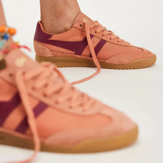 Side view of a Gola Tornado sneaker featuring a terracotta canvas and suede upper, burgundy leather stripes, gold Gola branding, and a gum rubber sole.
