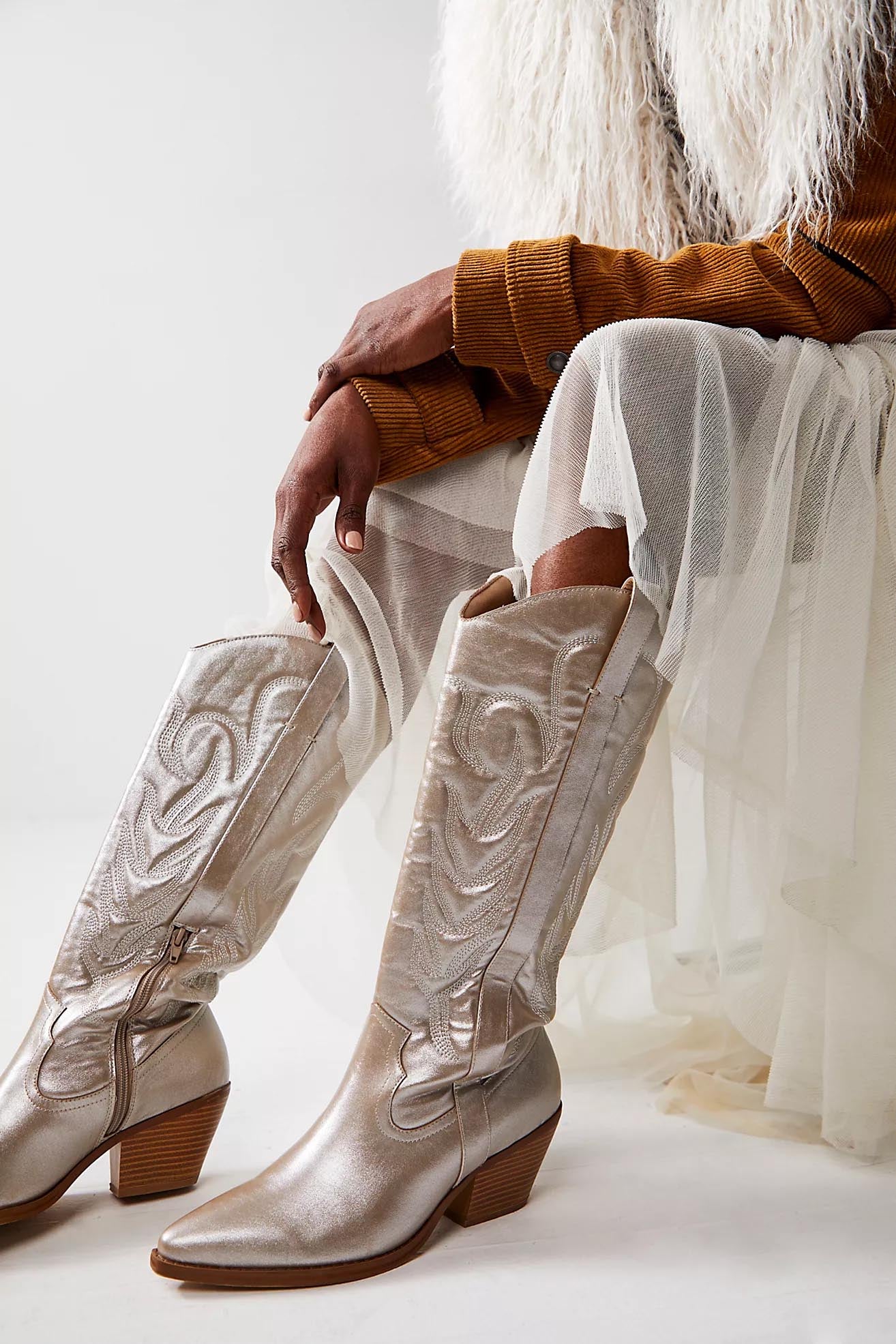 Metallic platinum western cowboy boots with embroidered detailing, pointed toe, and mid-block heel for women