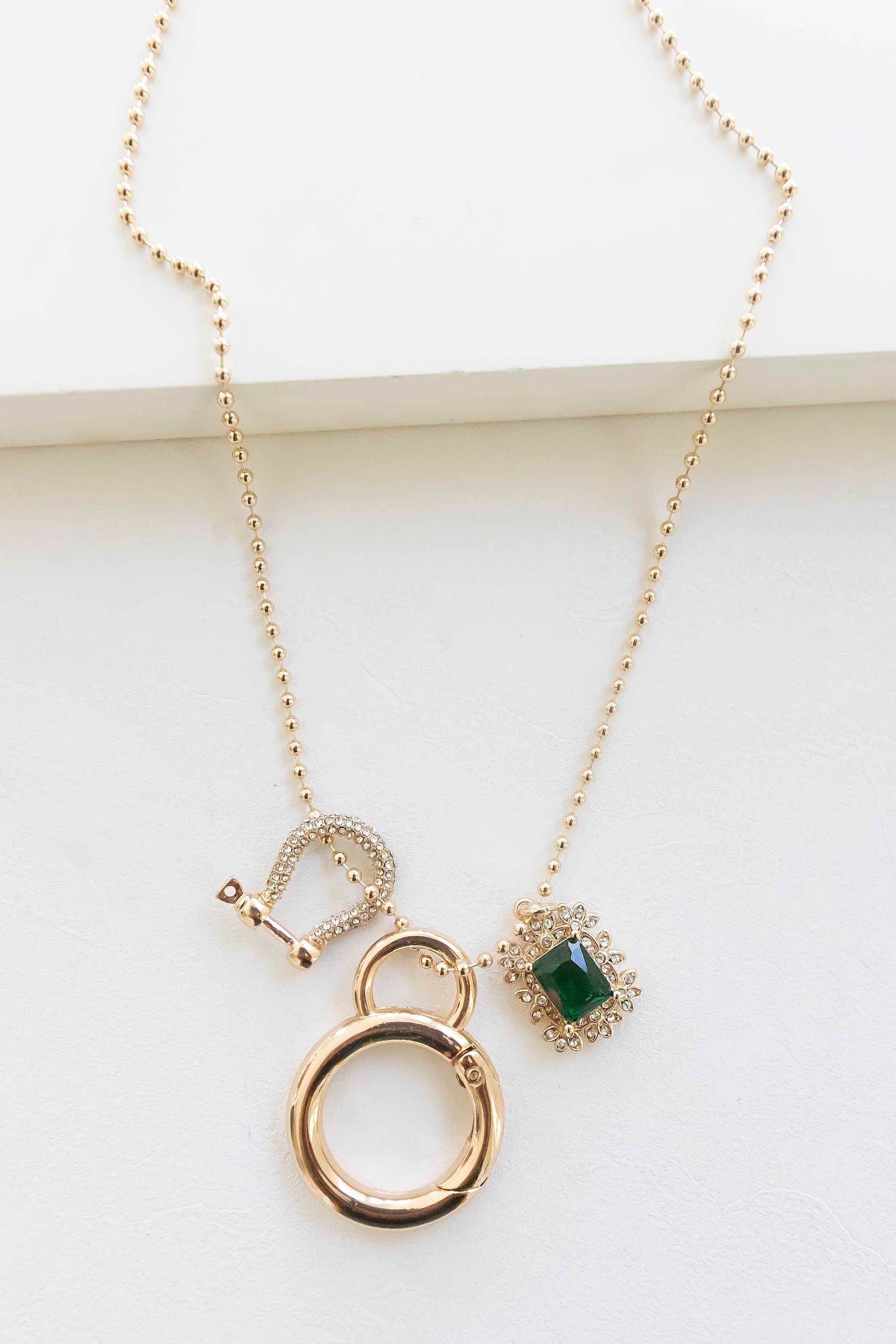 Eve Long Emerald Pendant Necklace | Long Gold Chain with Gold Horseshoe and Emerald Crystal Pendant Charms