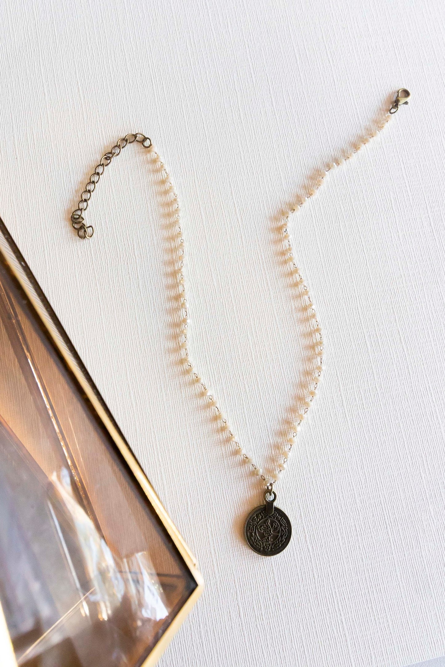 Load image into Gallery viewer, Jane Bronze Pendant Necklace | Dainty Renaissance Short Necklace | Cream Beads and Burnished Bronze Coin Pendant | Victorian Ancient Coin Charm
