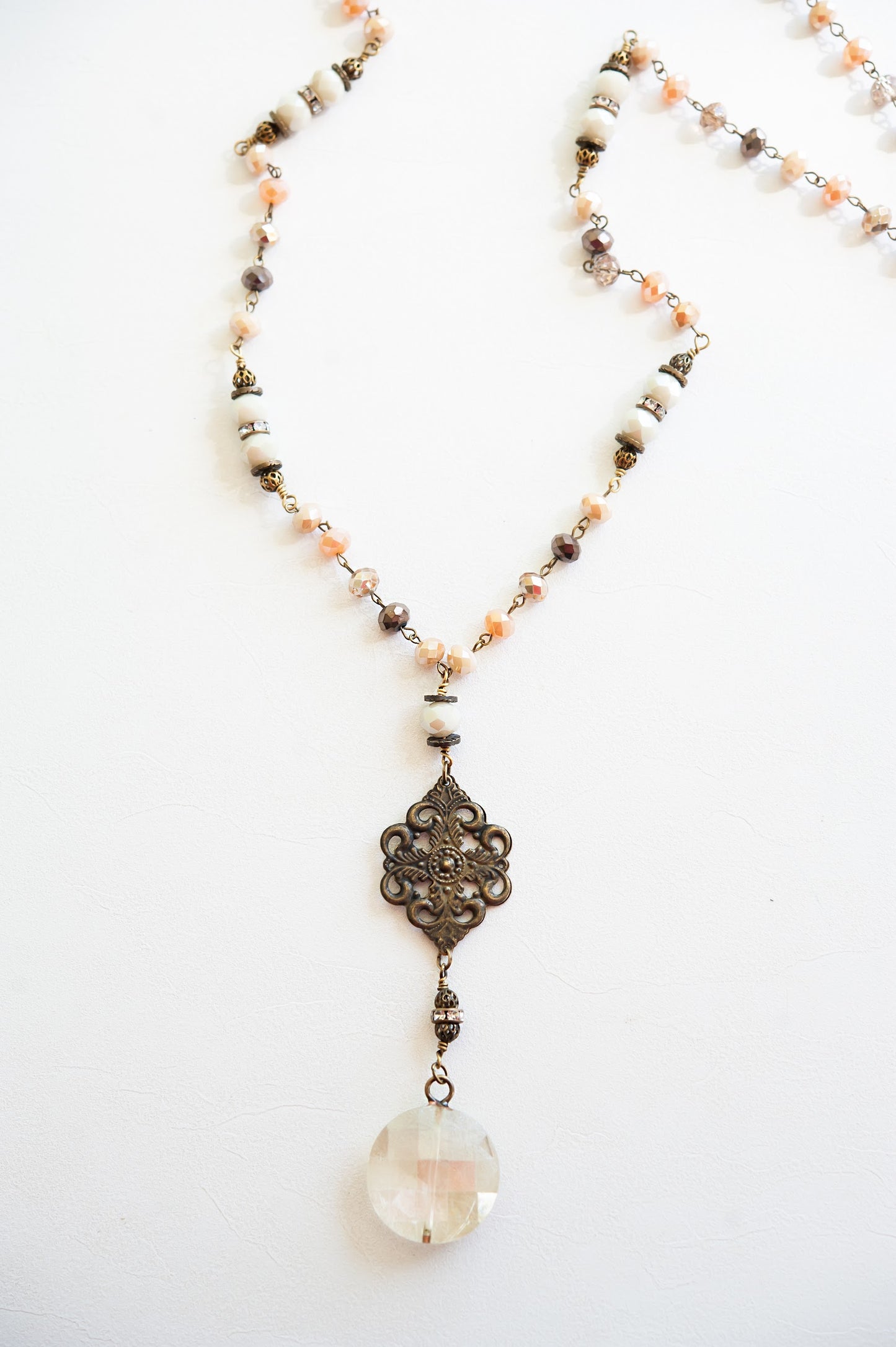 Load image into Gallery viewer, Marie Antique Chandelier Pendant Necklace | Vintage Burnished Bronze Filigree and Crystal Drop Pendant | Burnished Bronze Chain with Warm Blush Beads | Long Antique Royal Necklace
